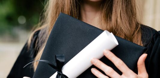 newly graduate student in black academic dress