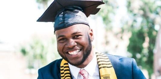 photo of man wearing graduation cap